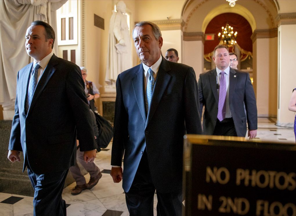 Speaker John Boehner, R-Ohio, center, walks to the House chamber Friday, when conservatives spurned a three-week Department of Homeland Security funding measure.  (J. Scott Applewhite/AP)