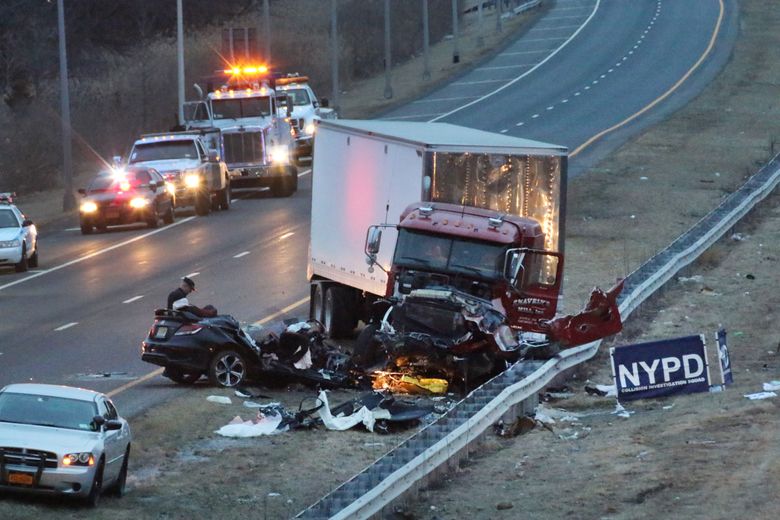 Police investigate the crash scene between a truck and a car carrying four people in the Staten Island borough of New York, Friday, March 20, 2015. The car, driving the wrong way and carrying three off-duty officers with the Linden, N.J. police department, crashed into the truck, killing one officer and another person and leaving two other officers critically injured, officials said. The truck driver was treated for injuries that weren’t considered to be life-threatening. (AP Photo/Staten Island Advance, Irving Silverstein)  MANDATORY CREDIT