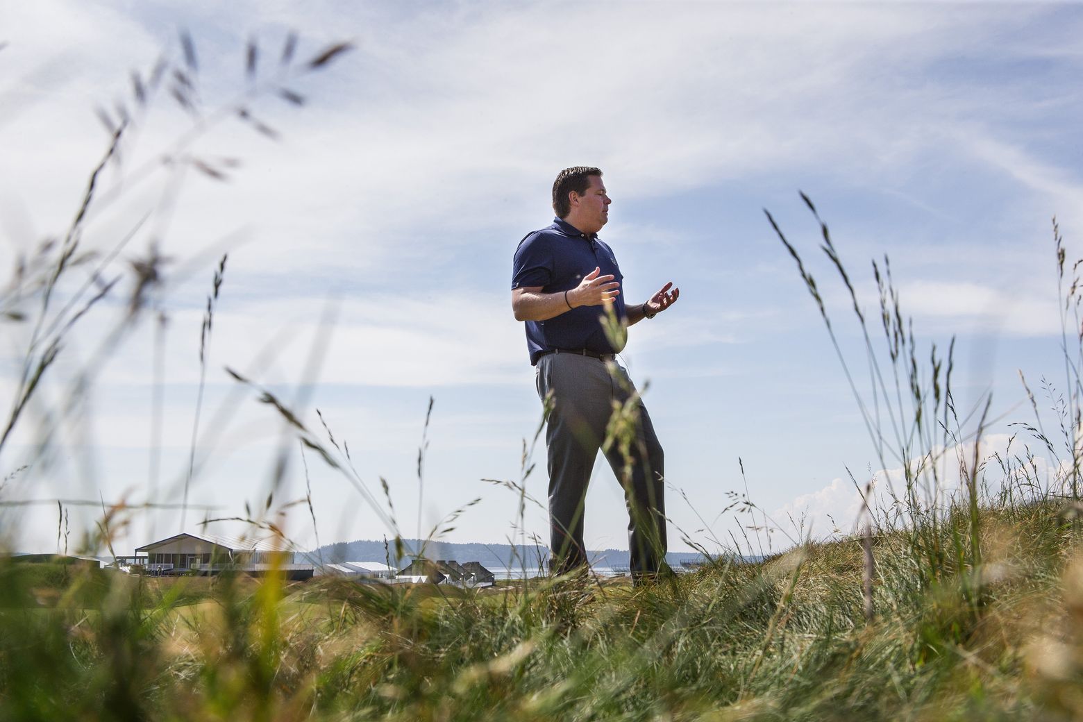 U.S. Open tournament director Danny Sink stands at Chambers Bay, which will feature four strains of fescue grass. The grass is expected to affect how the balls are played. (Dean Rutz/The Seattle Times)