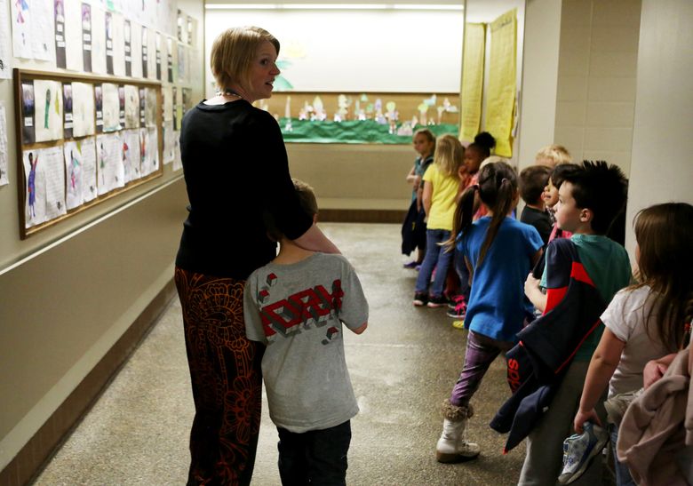 Kindergarten teacher Cassie Beck comforts a student having a tough day at Bemiss Elementary in Spokane. The school has adopted a trauma-informed approach that can work with all students and has sharply cut problem behaviors. (Ken Lambert/The Seattle Times)