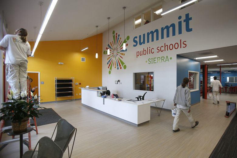 Employees of Washington Commercial Painters retouch the interior at the Summit Sierra charter school in Seattle after hours Friday. (Sy Bean / The Seattle Times)