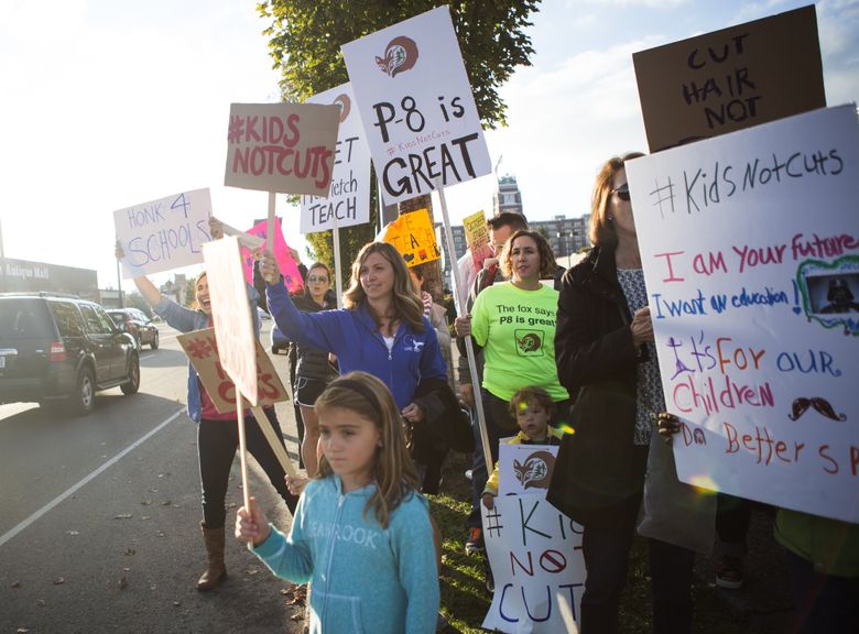 Parents, students and teachers protest teacher reassignments at Seattle Public Schools headquarters Tuesday. (Lindsey Wasson/The Seattle Times)