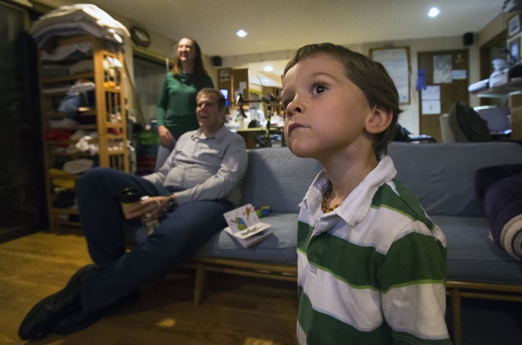 Gabriel Ruthford fixes his gaze on the television as he watches his favorite documentary about trains. (Sy Bean / The Seattle Times)
