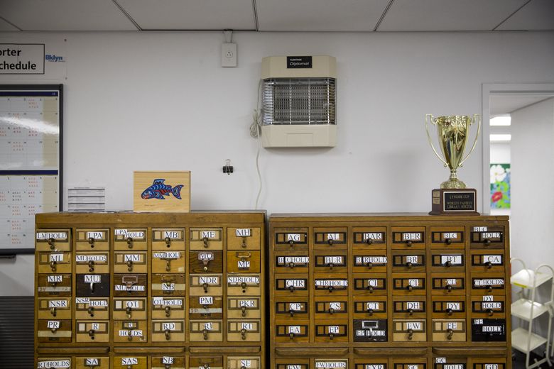 On top of a card catalog, a trophy for the “World’s fastest library sorter” sits in a New York Public Library facility in the Queens borough. (DAMON WINTER/NYT)