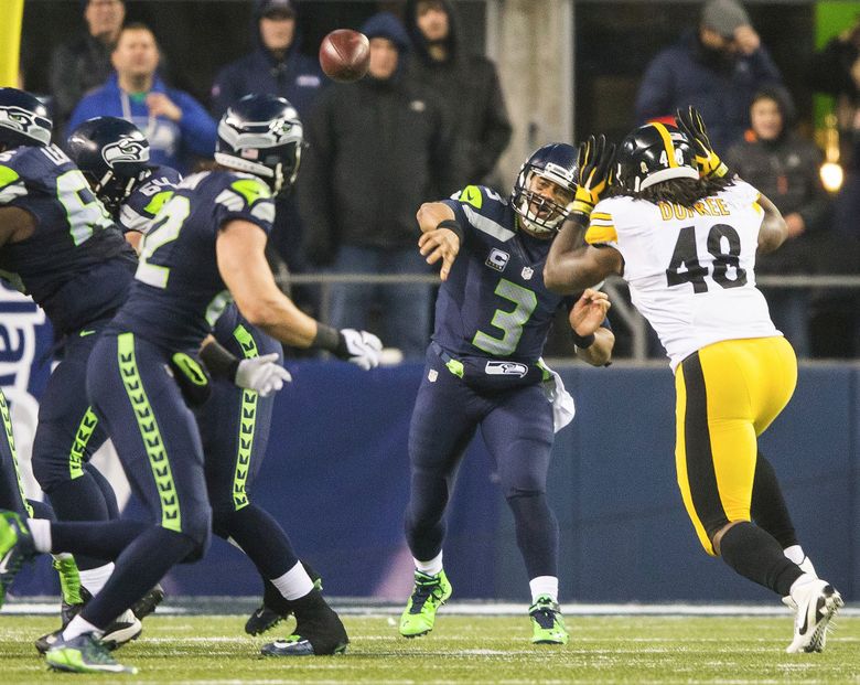 Russell Wilson throws a pass for Doug Baldwin for an 80-yard touchdown with 2:01 to play that would win the game for the Seahawks over Pittsburgh. (Dean Rutz/The Seattle Times)