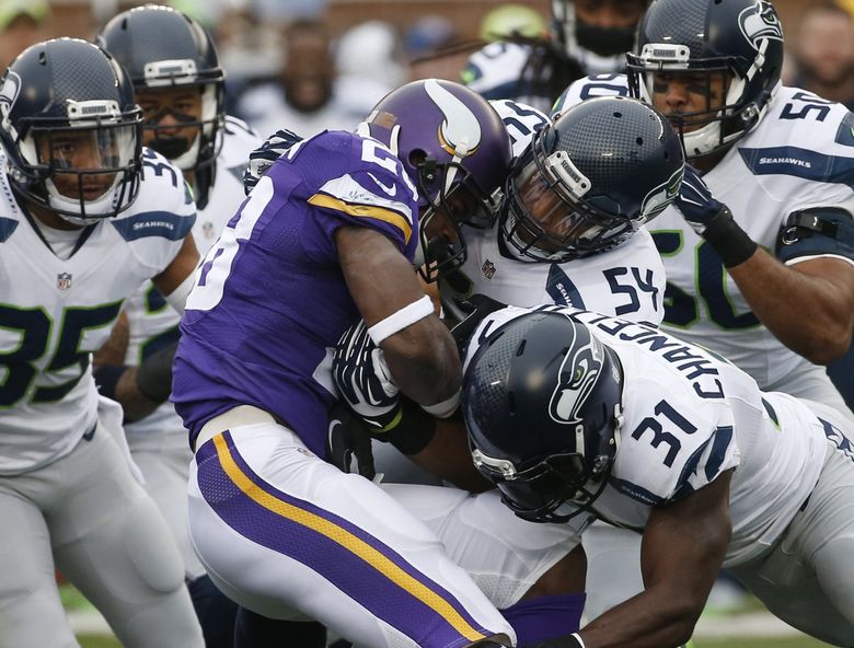 Minnesota Vikings running back Adrian Peterson (28) is stopped by Seattle Seahawks defenders including  linebacker Bobby Wagner (54) and strong safety Kam Chancellor (31)in the first half of an NFL football game Sunday, Dec. (28) is stopped by Seattle Seahawks defenders including  linebacker Bobby Wagner (54) and strong safety Kam Chancellor (31)in the first half of an NFL football game Sunday, Dec. 6, 2015 in Minneapolis. (AP Photo/Ann Heisenfelt)