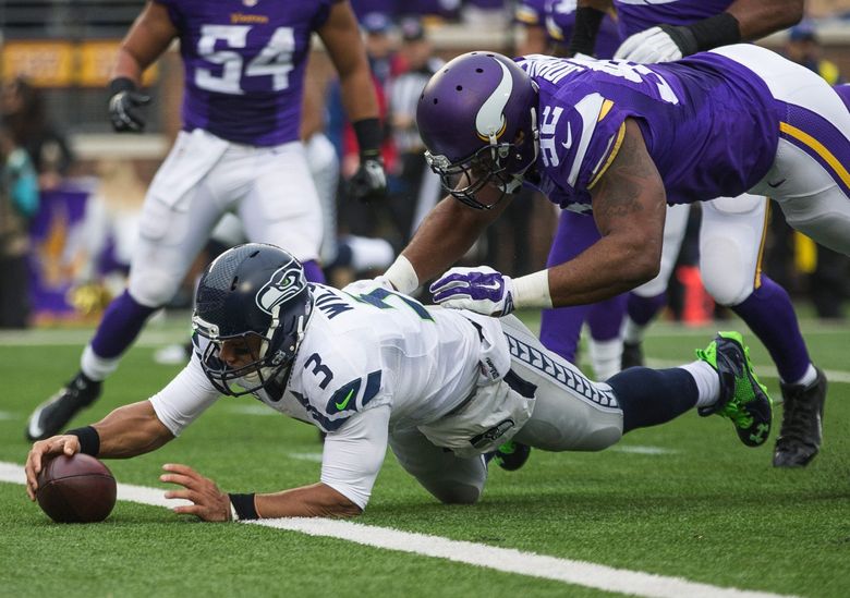 Russell Wilson falls into the end zone for a touchdown in the second quarter. (Dean Rutz / The Seattle Times)