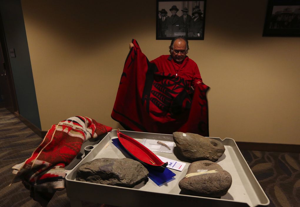 Lummi cultural leader Al Scott Johnnie with ancient reef net anchors, which are significant tribal artifacts at least 2,500 years old found at Cherry Point. (Alan Berner/The Seattle Times)