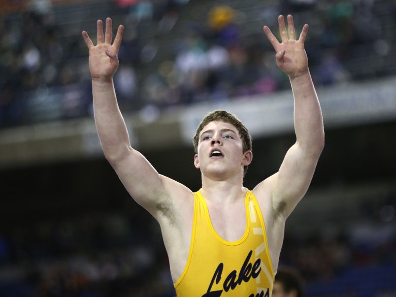 Michael Soler of Lake Stevens holds up some fours after winning his fourth title Saturday night at Mat Classic XXVIII. (Lindsey Wasson/The Seattle Times)