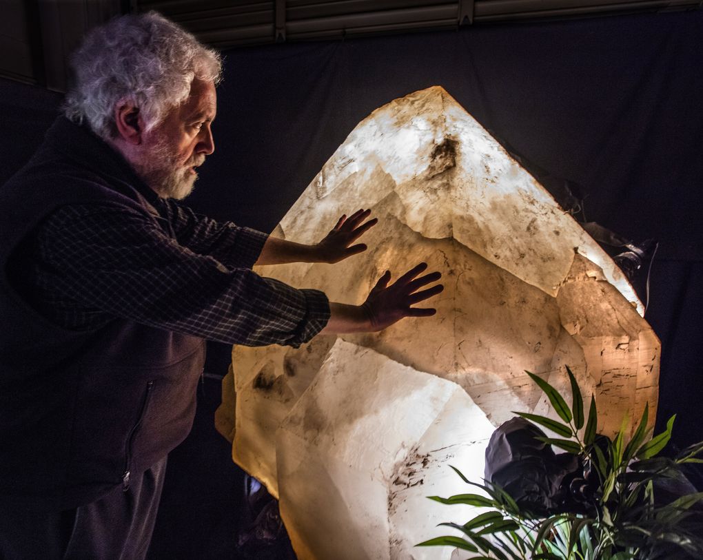 Richard Berger feels a 7,000-pound crystal from his collection of massive minerals. He hopes to keep it in the Northwest.  (Steve Ringman / The Seattle Times)