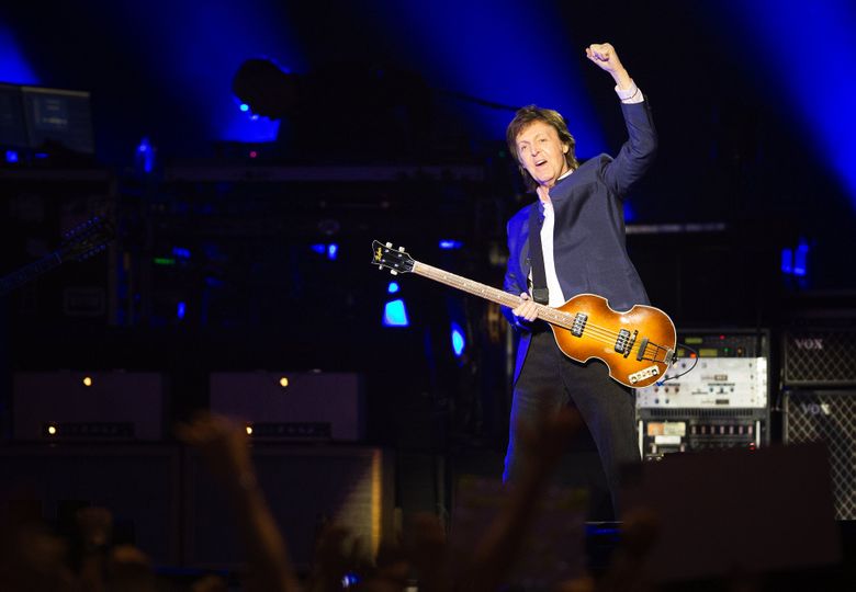 Paul McCartney waves at a full crowd as he arrives onstage during his “One on One” tour at KeyArena on Sunday, April 17, 2016. (Lindsey Wasson/The Seattle Times)