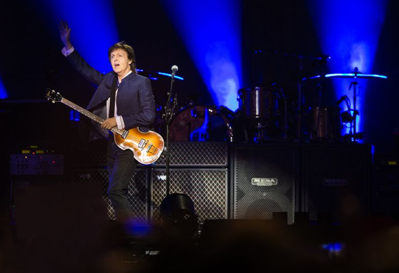 Sir Paul McCartney waves at a cheering crowd as he takes the stage for his “One on One” tour at KeyArena on Sunday, April 17, 2016. (Lindsey Wasson/The Seattle Times)