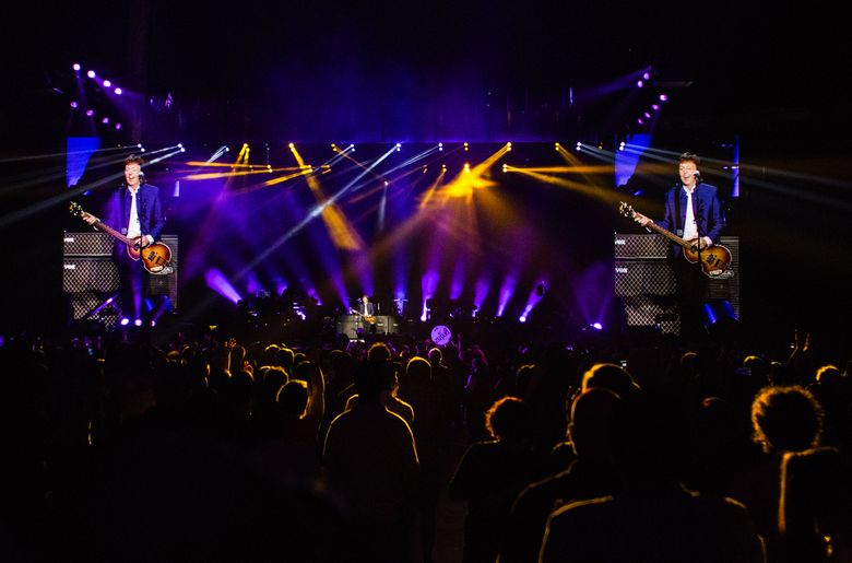 Video screens show live shots of Paul McCartney performing “Save Us” with his touring band during his “One on One” tour at KeyArena on Sunday, April 17, 2016. (Lindsey Wasson/The Seattle Times)
