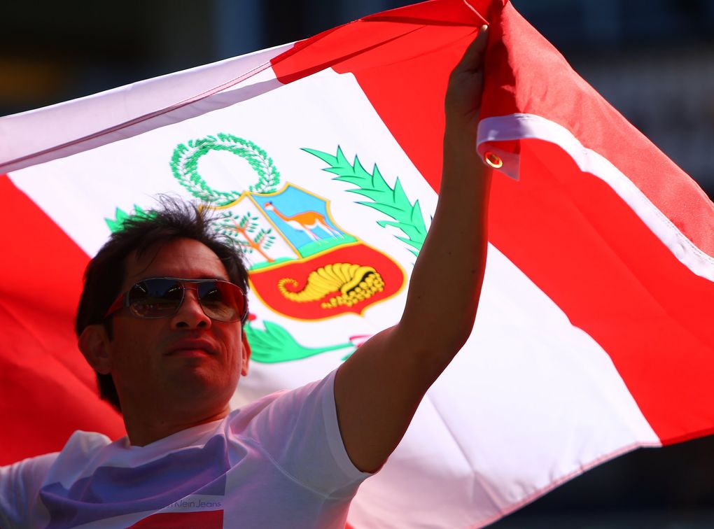 Guido Campana, originally from Trujillo, Peru, holds the Peruvian flag before the start of Saturday’s Copa America match 3 between Haiti and Peru at CenturyLink Field in Seattle. (Sy Bean / The Seattle Times)