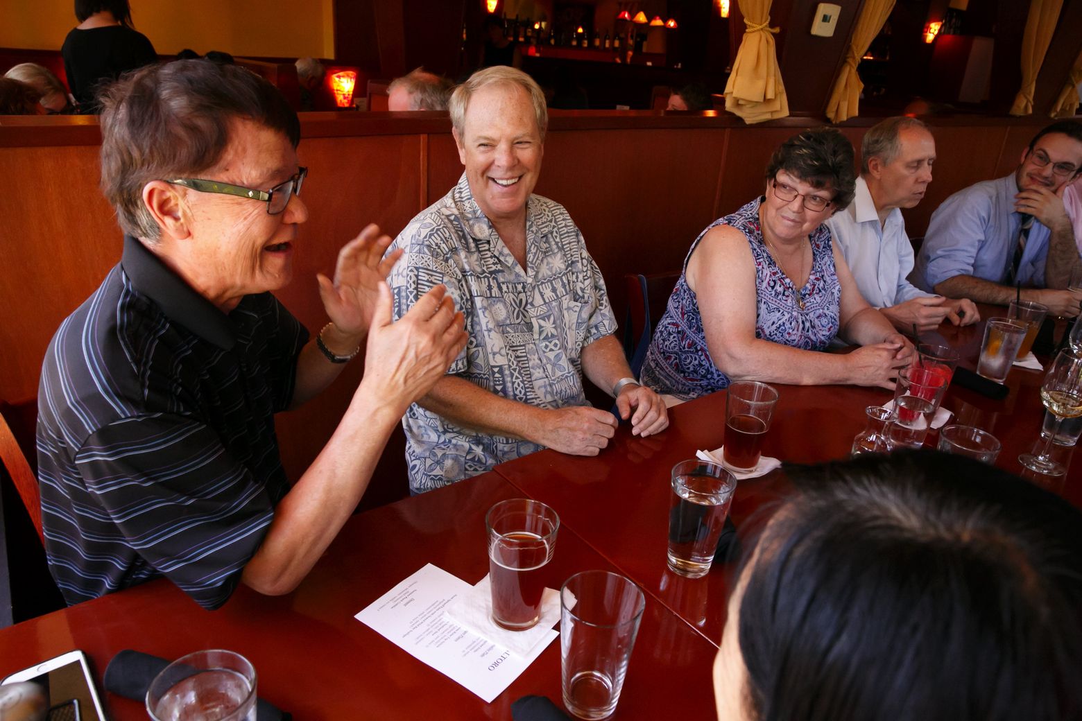 Joseph Huang, left, and Robert Bangs chat during a Prostate Club dinner gathering. (Erika Schultz/The Seattle Times)