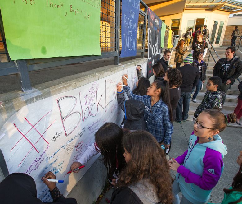 Chief Sealth International High School and Denny Middle School teachers and students hold a rally Wednesday morning to show their commitment to closing opportunity gaps and continuing the conversation on racial equity in their school. (Mike Siegel/The Seattle Times)