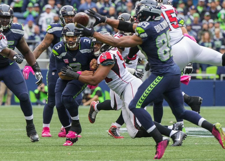 Seattle Seahawks quarterback Russell Wilson watches his pass go into the hands of wide receiver Doug Baldwin during 4th quarter action to keep a drive alive as the Seattle Seahawks play the Atlanta Falcons at CenturyLink Field on Sunday October 16th, 2016. (Mike Siegel/The Seattle Times)