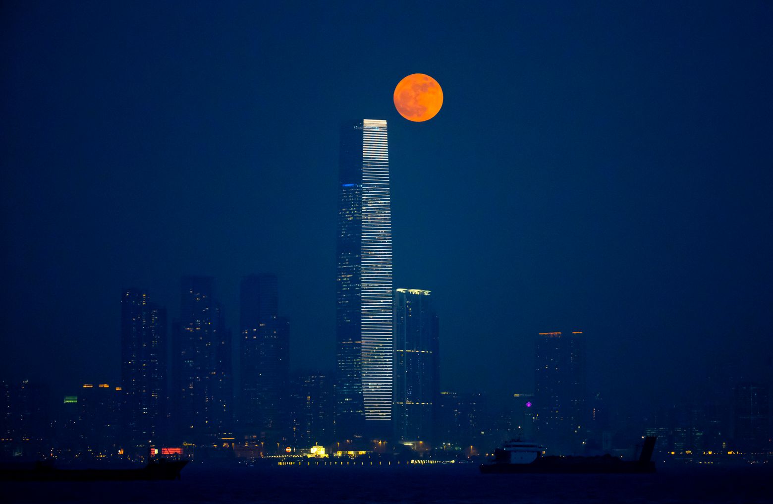 The moon rises over Victoria Harbour in Hong Kong, Monday, Nov. 14, 2016. The brightest moon in almost 69 years lights up the sky this week in a treat for star watchers around the globe. (AP Photo/Kin Cheung)
