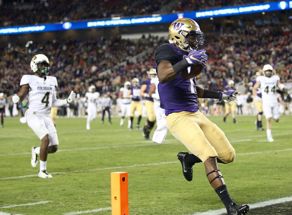Washington wide receiver John Ross runs in a touchdown in the third quarter to bring him within one touchdown of Mario Bailey’s PAC-12 record of 18. (Lindsey Wasson / The Seattle Times)