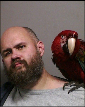 Jailbird’s feathered friend appears in Oregon mug shot