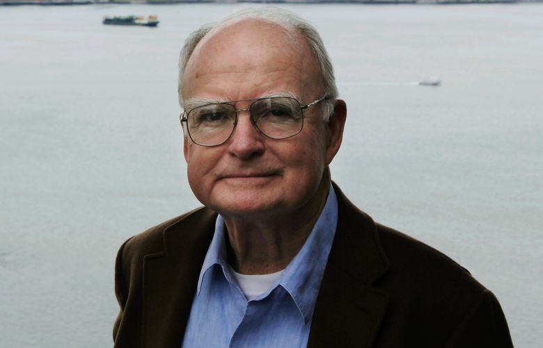 William Ruckelshaus, the first administrator of the EPA, poses for photos Monday, April 13, 2009 at his office in Seattle. Behind him is West Seattle and Puget Sound’s Elliott Bay. (AP Photo/Ted S. Warren)