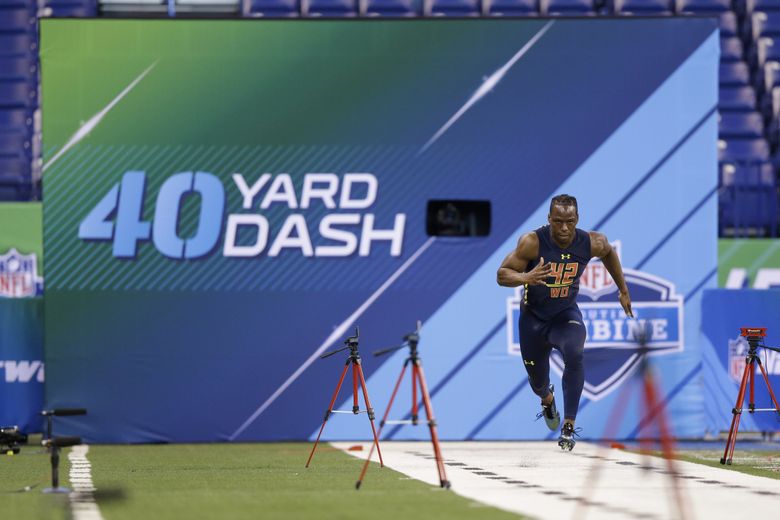 Washington wide receiver John Ross runs the 40-yard dash at the NFL football scouting combine in Indianapolis, Saturday, March 4, 2017. (AP Photo/Michael Conroy)