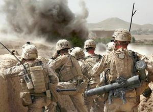 U.S. Marines watch an explosion after calling in an airstrike during a gunbattle in northern Helmand Province, Afghanistan. A 2007 study found Marines typically carry 97 to 135 pounds of gear, leading to increasing injuries. 