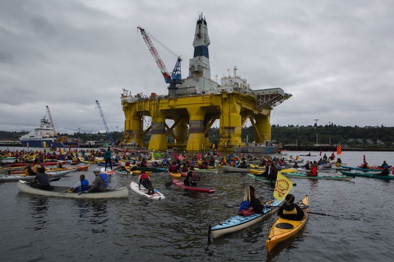 Activists in kayaks protest Saturday near the Polar Pioneer, Shell’s giant oil rig, which is moored at the Port of Seattle’s Terminal 5.  (Ellen M. Banner / The Seattle Times)
