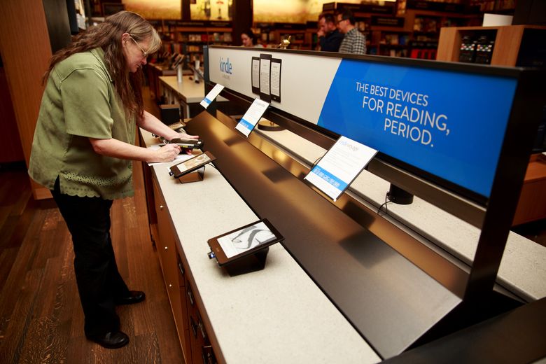 Katherine Sotol, books lead at Amazon Books, works at a technology display at Amazon Books in Seattle's University District (Erika Schultz/The Seattle Times)