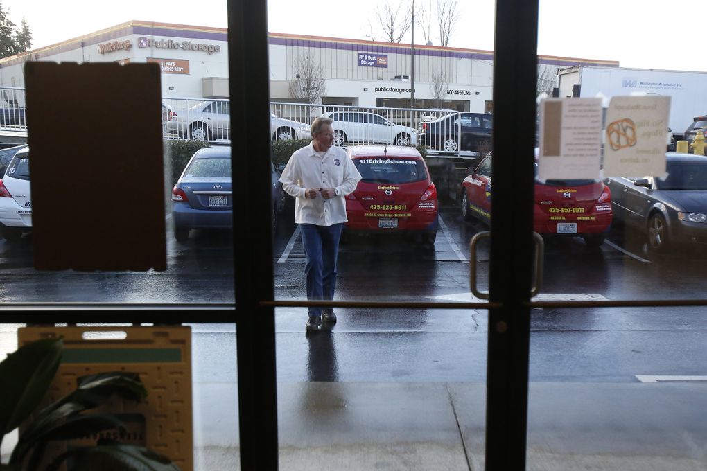 Instructor Steve Phelan walks into 9-1-1 Driving School before he gives driving lessons. (Sy Bean / The Seattle Times)