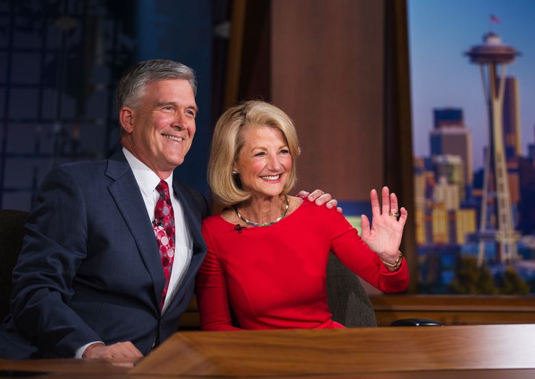KING 5 TV’s Jean Enersen and co-anchor Dennis Bounds smile for a photo before Enersen’s last 5 p.m. broadcast as a daily news anchor in 2014. Enersen and Bounds after accepted voluntary buyout offers.  (LINDSEY WASSON/The Seattle Times )