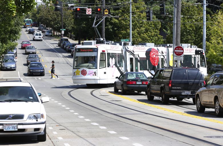 When building the First Hill Streetcar, shown here at the intersection of East Yesler Way and 14th Avenue, the city tried to protect cyclists by putting streetcar tracks in the center of the street and creating separate bike lanes. (Ken Lambert/The Seattle Times)