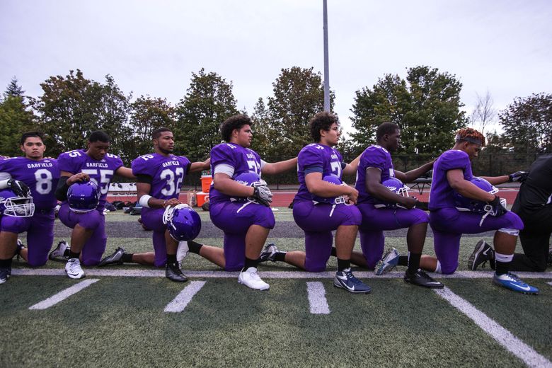 Garfield football team takes knee during national anthem ...
