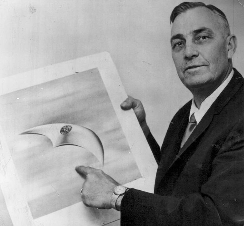 Kenneth Arnold, shown in 1966 with a drawing of a flying saucer, reportedly spent “many long hours of fruitless flying with a camera, trying and failing to find anything like his saucers again.”  (AP)