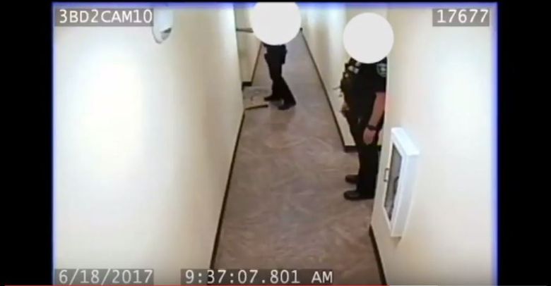 Unidentified Seattle police officers are shown in surveillance video outside of Charleena Lyles’ apartment in Magnuson Park, shortly before the officers opened fire and killed the pregnant black women. Police say Lyles brandished a knife before they shot her. (Seattle Police Department / YouTube)