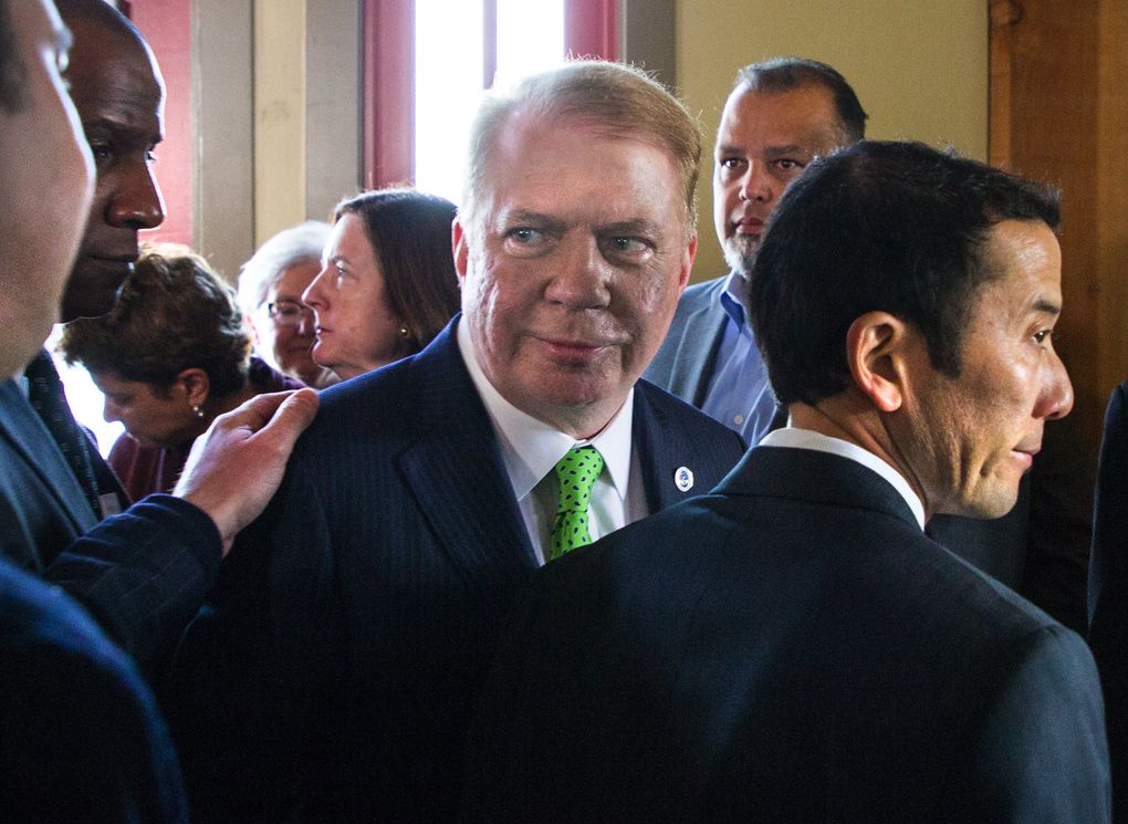Mayor Ed Murray and his husband, Michael Shiosaki, right, leave a May 9 news conference at which the mayor ended his re-election bid.  (Mike Siegel/The Seattle Times)