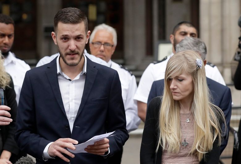 Chris Gard, the father of critically ill baby Charlie Gard finishes reading out a statement next to mother Connie Yates, right, at the end of their case at the High Court in London, Monday, July 24, 2017. The parents of critically ill baby Charlie Gard dropped their legal bid Monday to send him to the United States for an experimental treatment after new medical tests showed that the window of opportunity to help him had closed. (AP Photo/Matt Dunham)