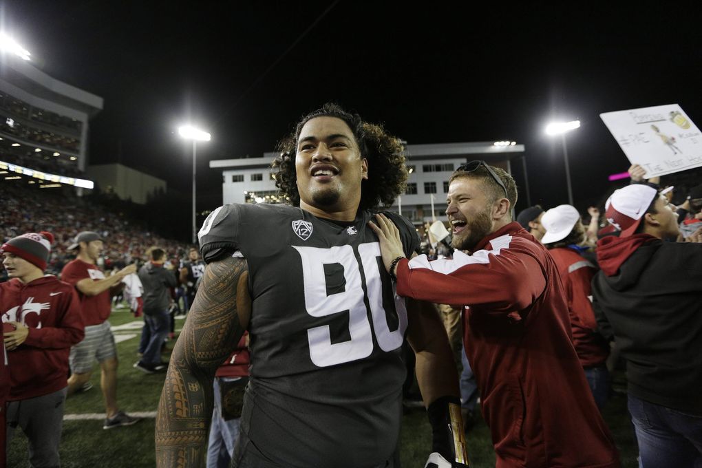 Washington State defensive lineman Daniel Ekuale (90) celebrates with fans after his team won an NCAA college football game against Southern California in Pullman, Wash., Friday, Sept. 29, 2017. (AP Photo/Young Kwak) OTK OTK (Young Kwak / The Associated Press)