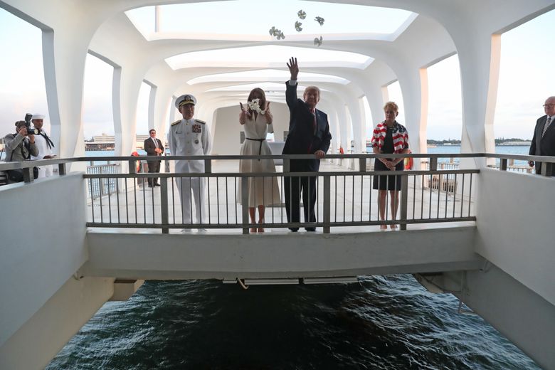 CAPTION ADDITION LOCATION: U.S. President Donald Trump and first lady Melania Trump offer flowers at the USS Arizona Memorial in Pearl Harbor, Honolulu, Hawaii, Friday, Nov. 3, 2017. Trump begins a five country trip through Asia traveling to Japan, South Korea, China, Vietnam and the Philippines. (AP Photo/Andrew Harnik)
