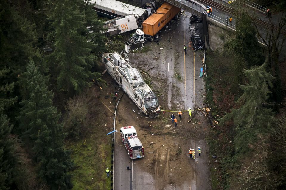 The Amtrak train derailed and fell off a bridge, landing on southbound Interstate 5 near Mounts Road, between Lakewood and Olympia, Washington. This view looks northeast, with the lead engine in the foreground near a firetruck.  Photograph: Bettina Hansen/The Seattle Times.