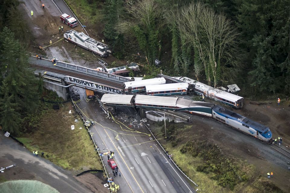 An Amtrak train derailed,  falling off a bridge and onto Interstate 5 near Dupont on Monday. This view looks southwest over the southbound lanes. The lead engine is seen on the highway beyond the overpass.  Photograph: Bettina Hansen/The Seattle Times.