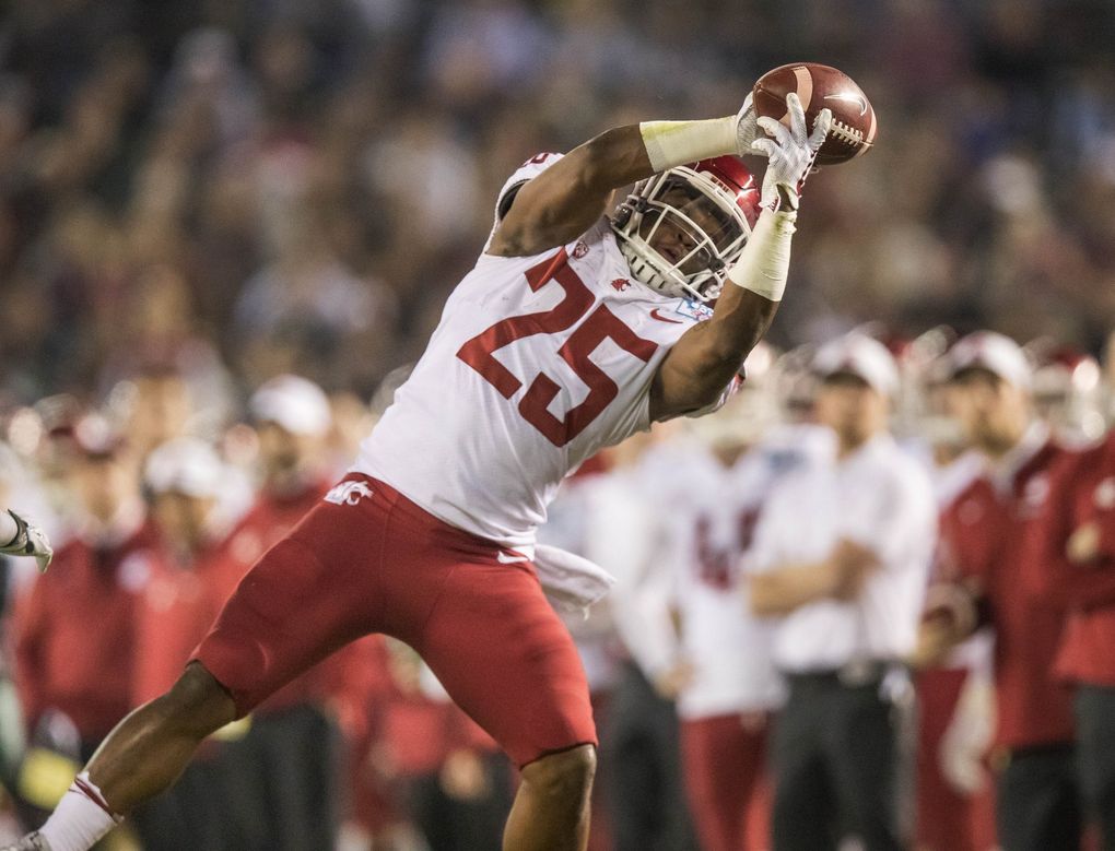 Washington State’s Jamal Morrow hangs on to the ball thrown by Tyler Hilinski,  for a 1st down at the 28 in the first quarter.  (Dean Rutz / The Seattle Times)