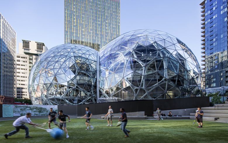 BOOM (Seattle): The Amazon Biosphere in downtown Seattle with Amazon employees playing broomball.  (Steve Ringman/The Seattle Times)