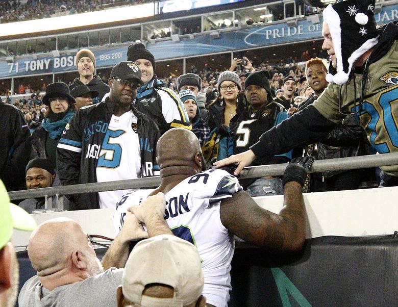 Seattle Seahawks defensive tackle Quinton Jefferson, center, tries to climb up in the stands after Jacksonville Jaguars fans threw objects at him at the end of an NFL football game, Sunday, Dec. 10, 2017, in Jacksonville, Fla. Jacksonville won 30-24. (AP Photo/Stephen B. Morton) JVS126 JVS126 (Stephen B. Morton / The Associated Press)