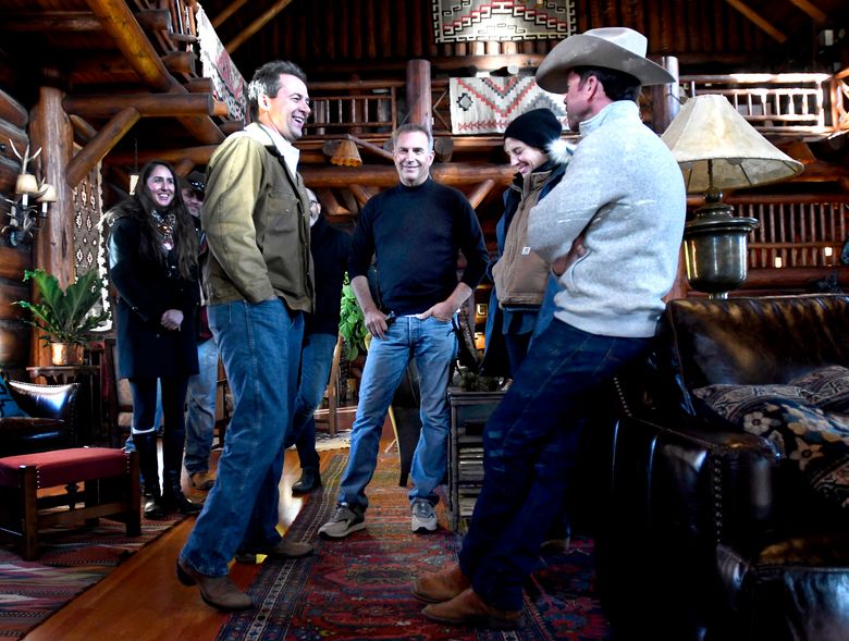 In this Dec. 7, 2017 photo, Montana Gov. Steve Bullock, foreground from left, appears with actor Kevin Costner, production designer Ruth De Jong and writer-director Taylor Sheridan in the lodge at the Chief Joseph Ranch during a visit to the set of the television series  “Yellowstone” in Darby, Mont. The series is set for release in June. (Kurt Wilson/The Missoulian via AP)