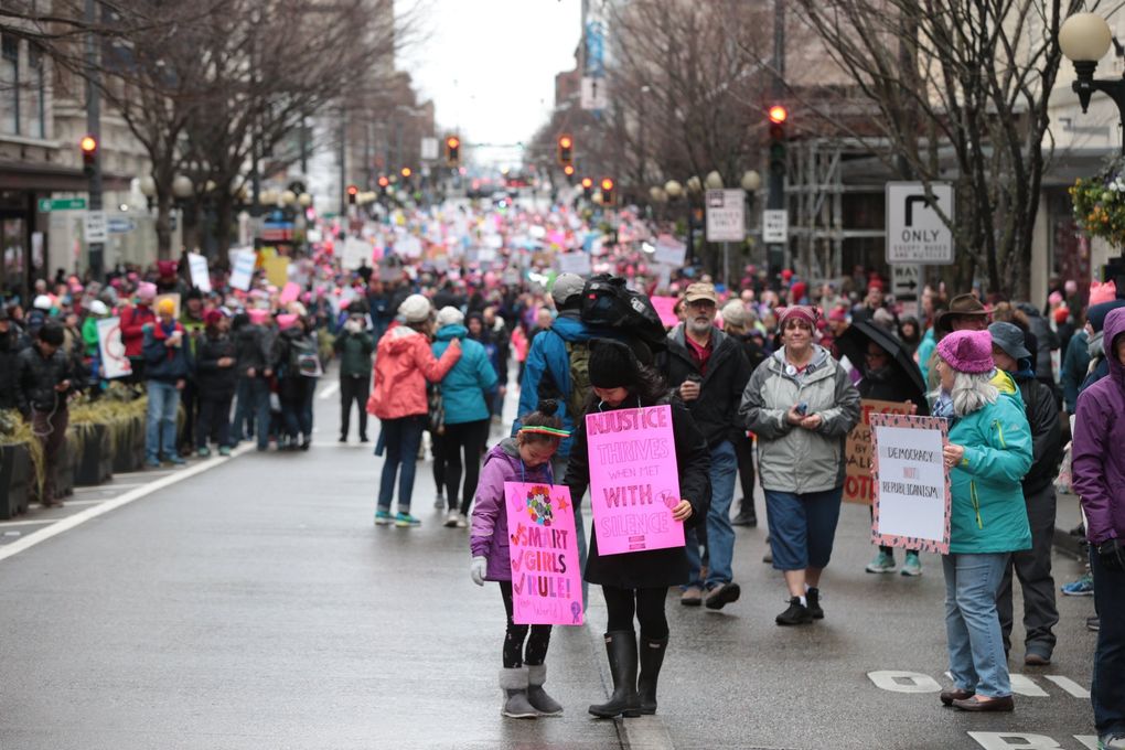 Young Filer and her daughter Hahna, 8 stand along Pine Street during the Seattle Women’s March, Saturday. “I just want her not to have the same battles when she is my age,” said Young. “I thought we were ahead of all this.” (Bettina Hansen / The Seattle Times)