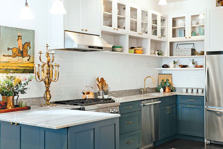 Homeowners are injecting rich colors such as blues and grays in kitchens to balance the classic white elements. (Houzz via The Washington Post)