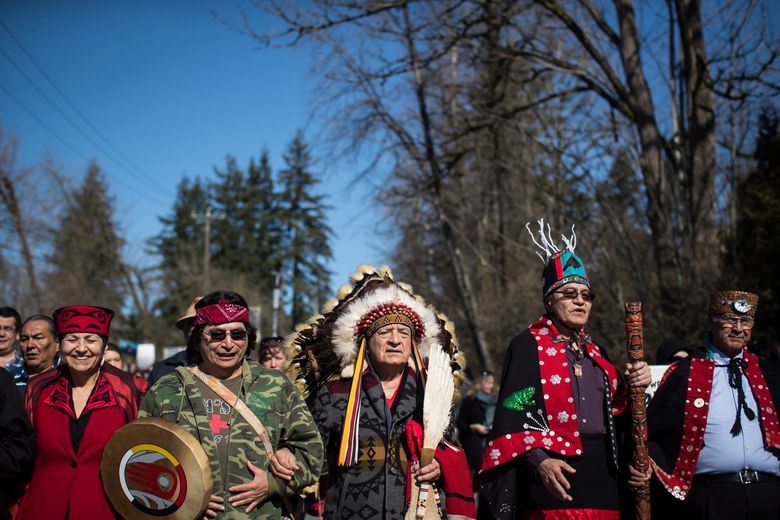 Hereditary Chief Phil Lane Jr., center, joins other indigenous chiefs and elders in leading thousands of people in a march during a protest against the Kinder Morgan Trans Mountain pipeline expansion in Burnaby, British Columbia, Saturday, March 10, 2018. (Darryl Dyck/The Canadian Press via AP)