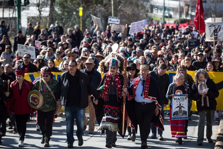 Indigenous chiefs and elders lead thousands of people in a march during a protest against the Kinder Morgan Trans Mountain pipeline expansion in Burnaby, British Columbia, Saturday, March 10, 2018. (Darryl Dyck/The Canadian Press via AP)