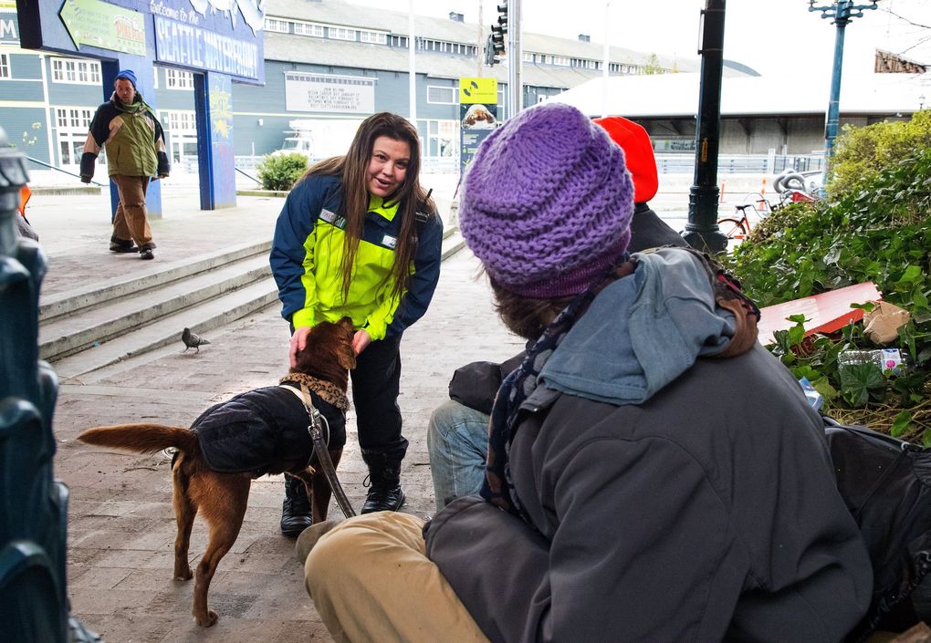 Fawn Batten is greeted by Charlie the dog, who recognizes her as she approaches. (Mike Siegel / The Seattle Times)
